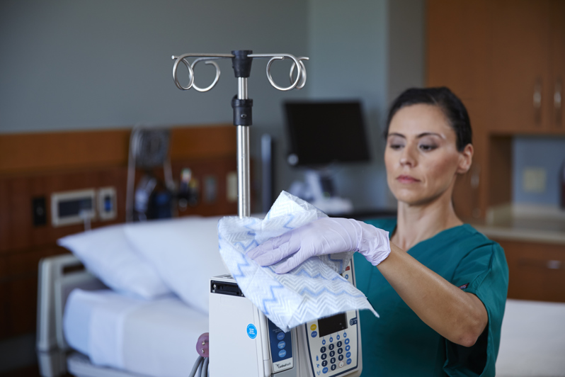 Nurse cleaning hospital equipment with Disposable Microfibre Cloth
