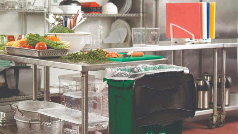 Rubbermaid Commercial Products Slim Jim trash can features a green plastic body and a stainless steel mobile dolly for easy transport